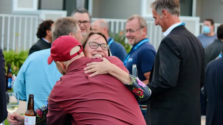 Allyson Hartzell giving Tim Brosnihan a welcome hug at MSEC 2021